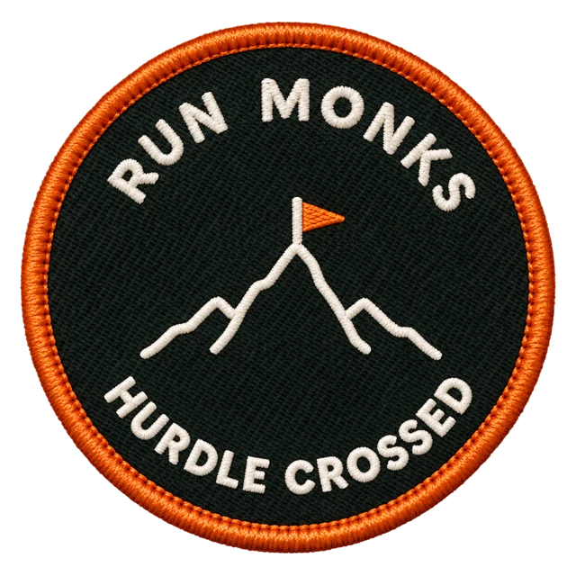 Hurdle crossed badge: a mountain with a flag